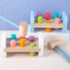 Sba3ae99313ce4e269c8db5b328d3cb02N.jpg Wooden Colorful Pounding Toy Features assorted colorful pegs and a wooden hammer Kids have a blast hammering away